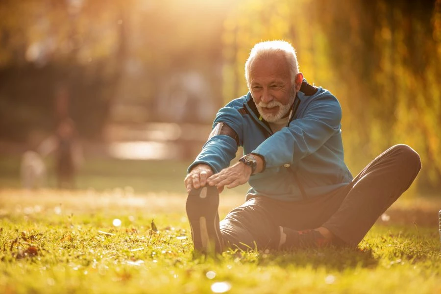Senior man stretching outside
